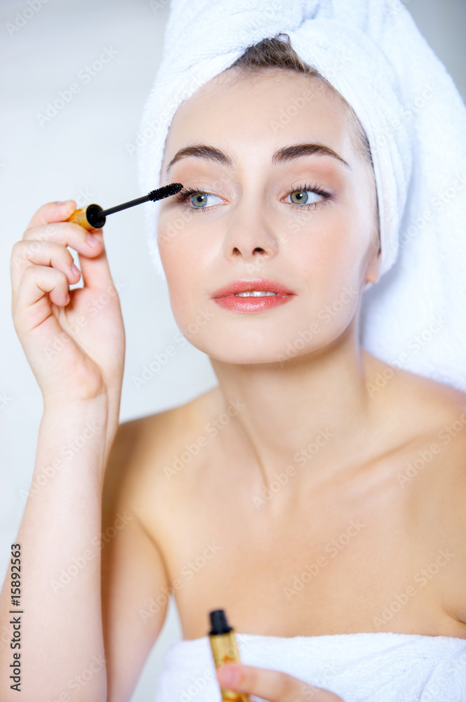 Portrait of cute teenage girl doing morning makeup