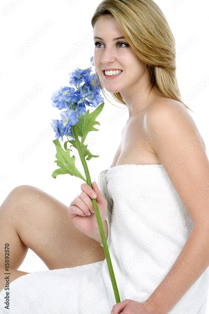 Female model holding a blue flower on a white background Female model holding a blue flower on a white background