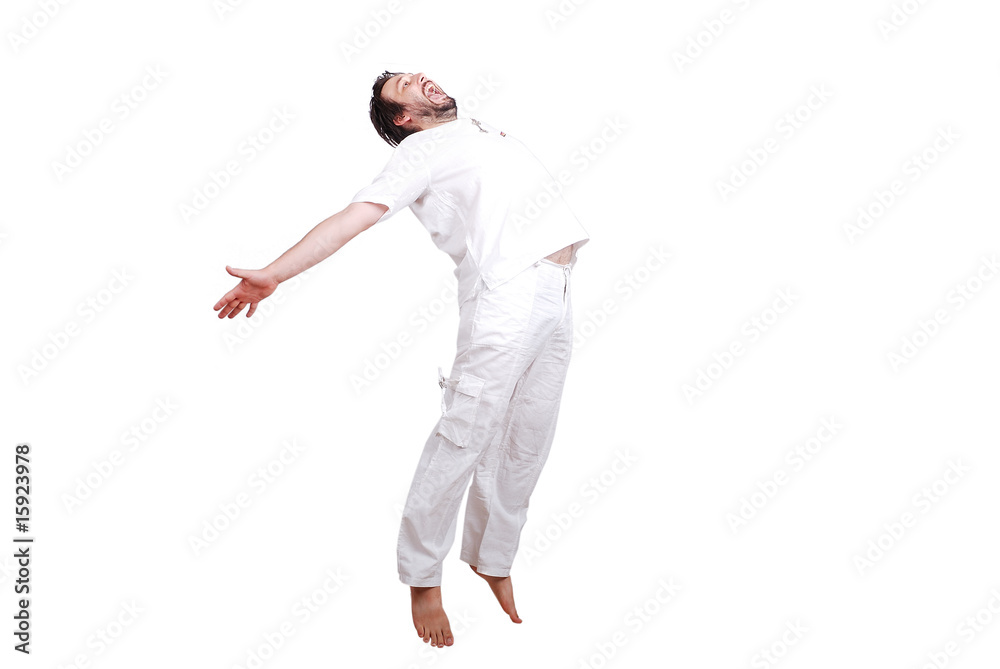 Obraz premium Happy young male in white clothes is jumping isolated