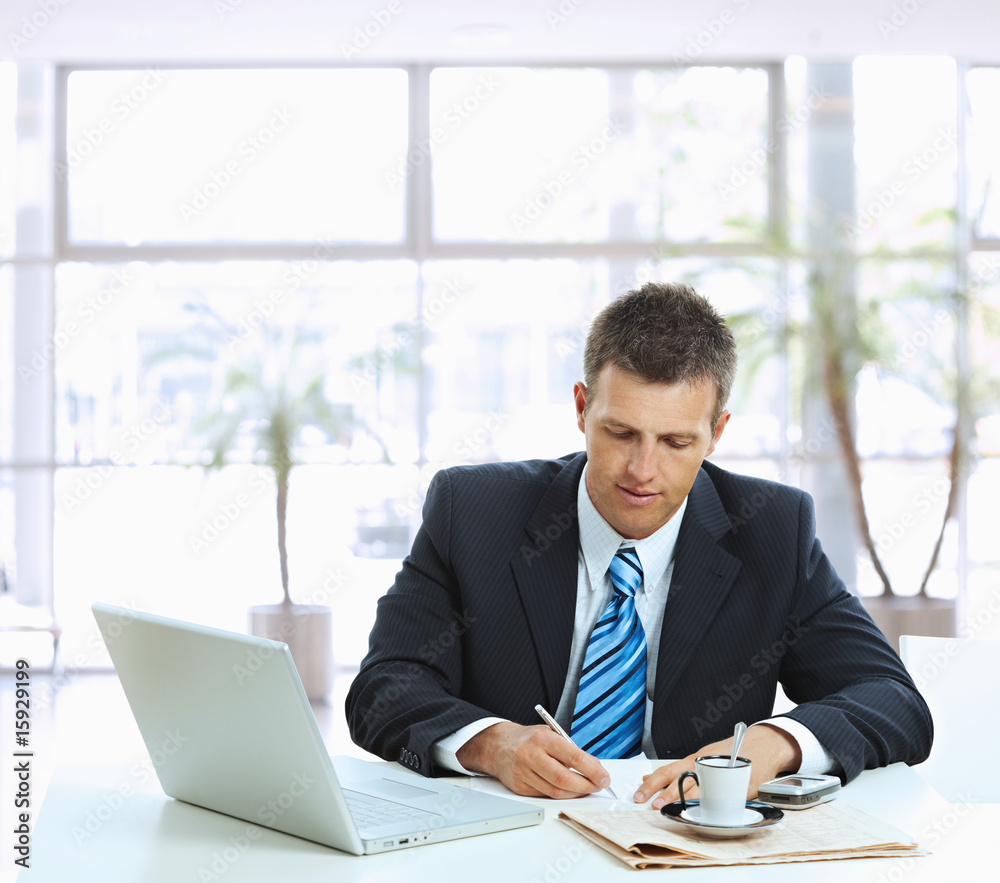 Businessman writing notes Businessman writing notes