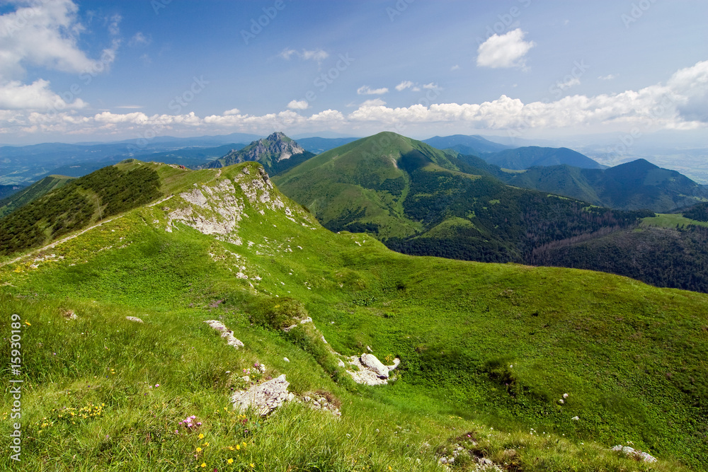 Obraz premium Mountain-ridge and blue sky with white clouds
