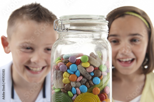 Girl & boy looking at sweet jar