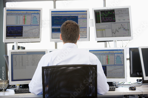 Billede på lærred Stock Trader Looking At Multiple Monitors