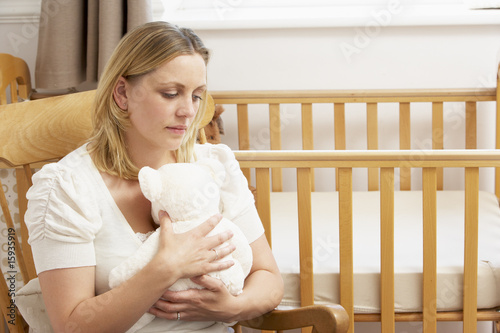 Sad Mother Sitting In Empty Nursery