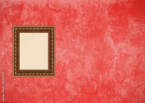Grunge red stucco wall with empty picture frame