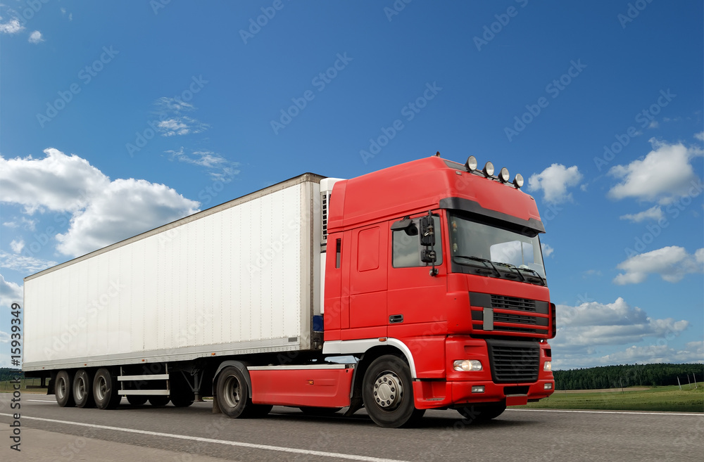 Red lorry with white trailer over blue sky Red lorry with white trailer over blue sky