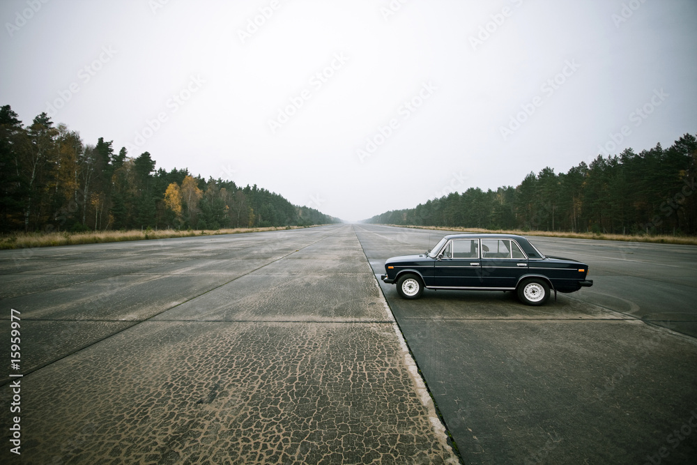 lonely old car on an airstrip