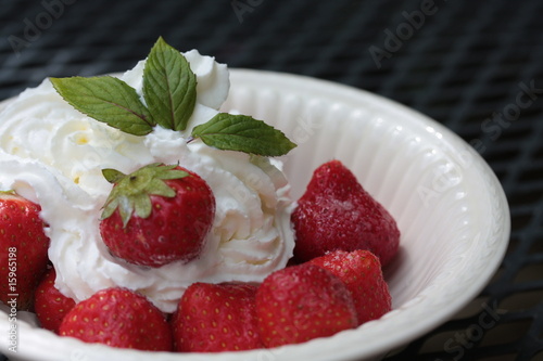 strawberries with cream  decorated with mint leaves