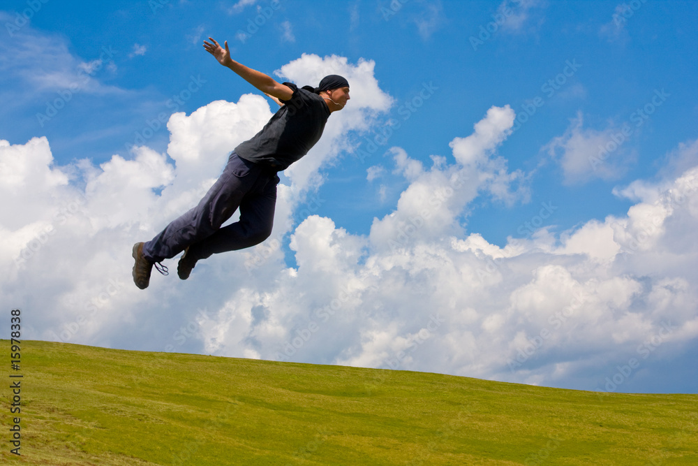 Man jump over meadow