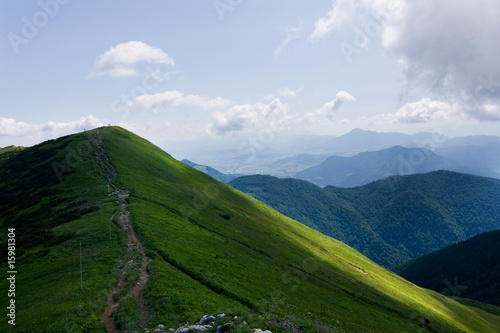 Mountain-ridge and blue sky with white clouds photo