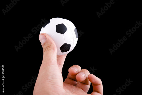Hand holding football ball