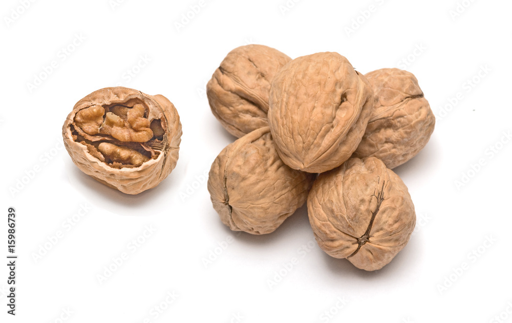 Cracked walnut and pile of walnuts isolated on white background Cracked walnut and pile of walnuts isolated on white background