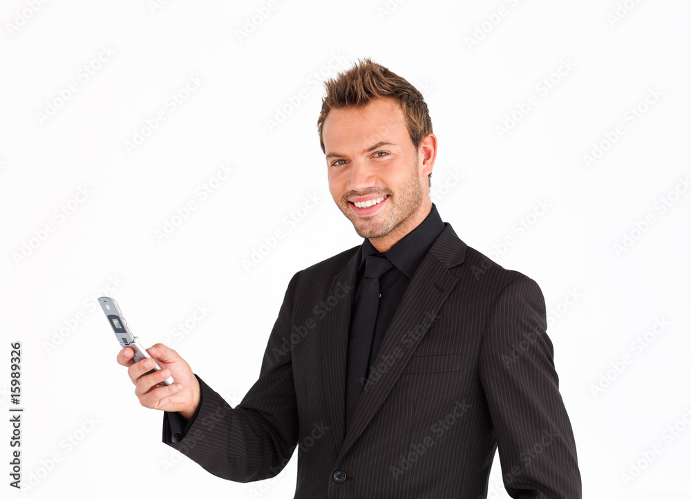 Young businessman texting and smiling at the camera Young businessman texting and smiling at the camera