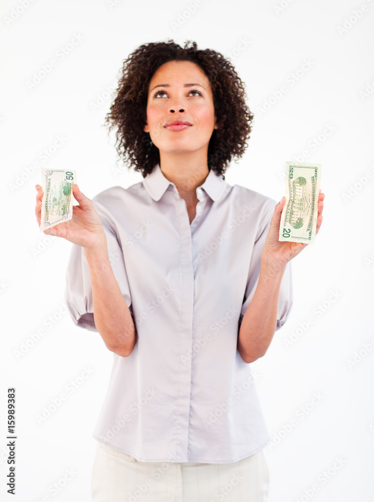 Serious businesswoman holding dollars and looking upwards Serious businesswoman holding dollars and looking upwards