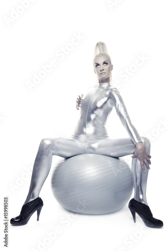 Beautiful cyber woman sitting on a silver ball