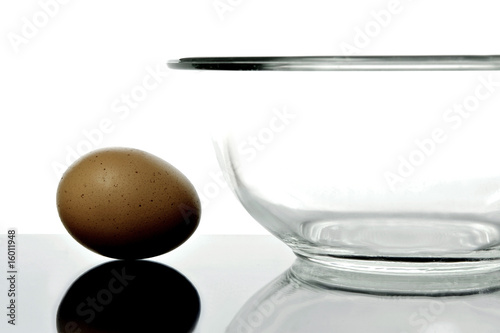 An egg and a glass bowl isolated and backlit