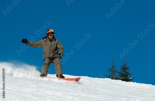 Snowboarder riding down the hill