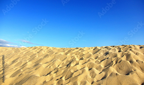 Texture of sand and blue sky.