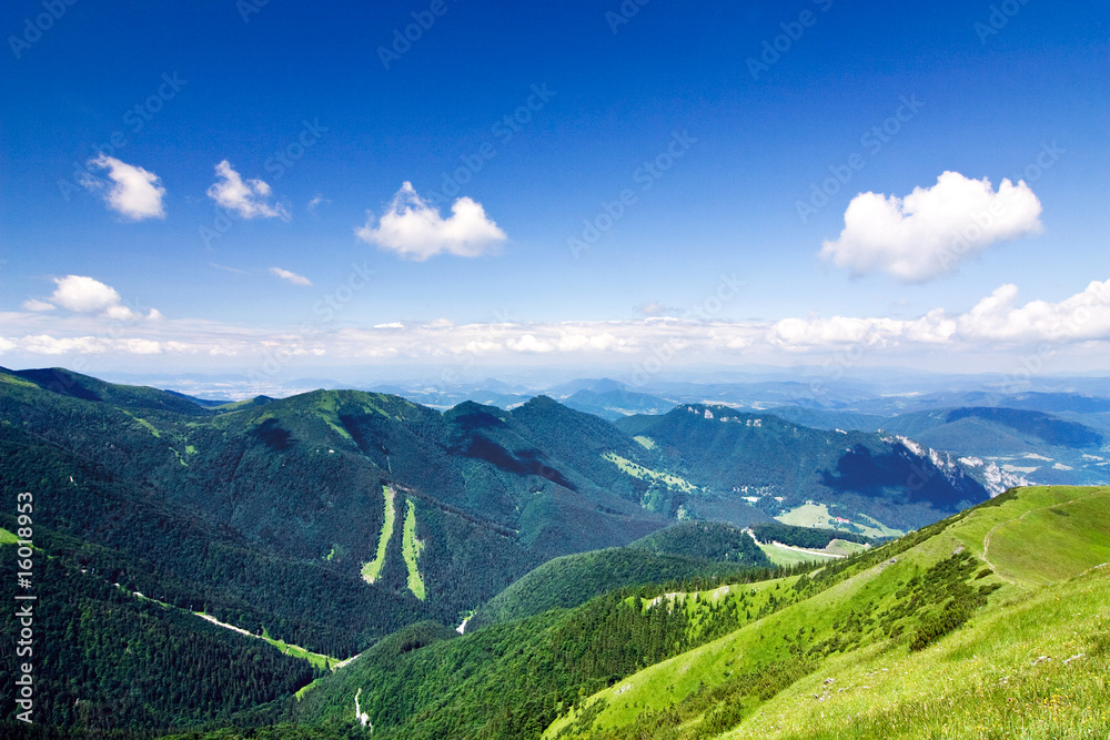 Fototapeta premium Mountain-ridge and blue sky with white clouds