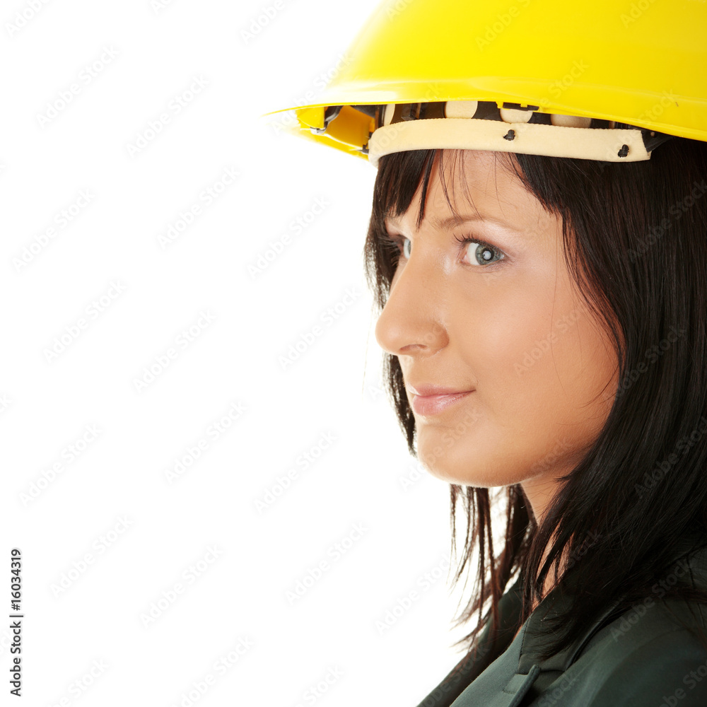 Young female architect or builder wearing a yellow hart hat Young female architect or builder wearing a yellow hart hat