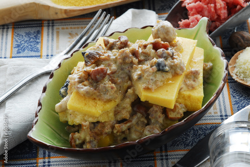 Polenta pasticciata con salsiccia ,tartufo, porcini e grana photo