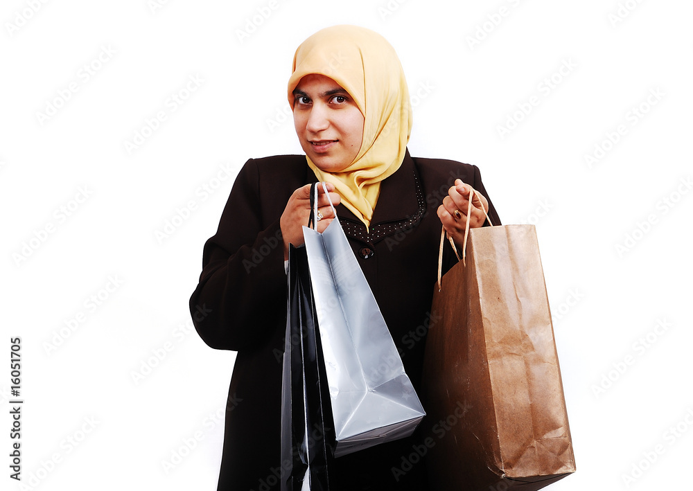 Young muslim female in traditional clothes with bags