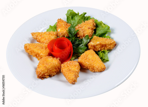 Appetizing fried chicken nuggets with tomatoes