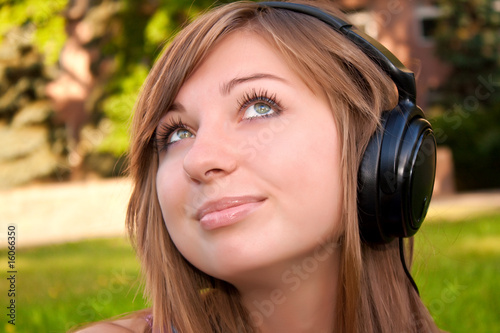 Young woman listen to the music with headphones