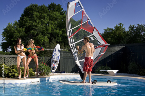 2 girl a guy and a pool photo