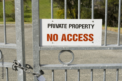 Private Property - No Access Sign on a Padlocked Gate