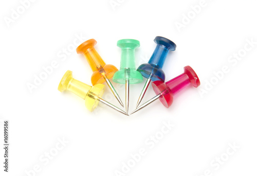 Different color drawing-pins on white background
