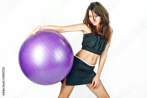 Young woman on white background in a fitness pose