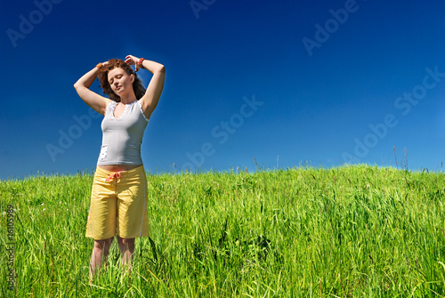 Young woman on the green field