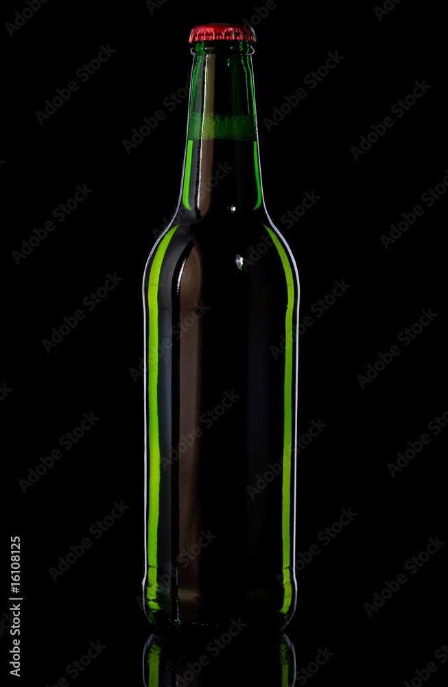 Green bottle with beer on black background Green bottle with beer on black background