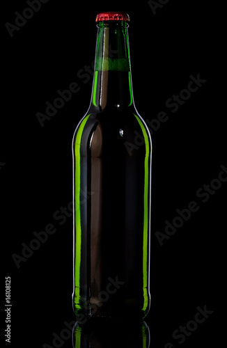 Green bottle with beer on black background