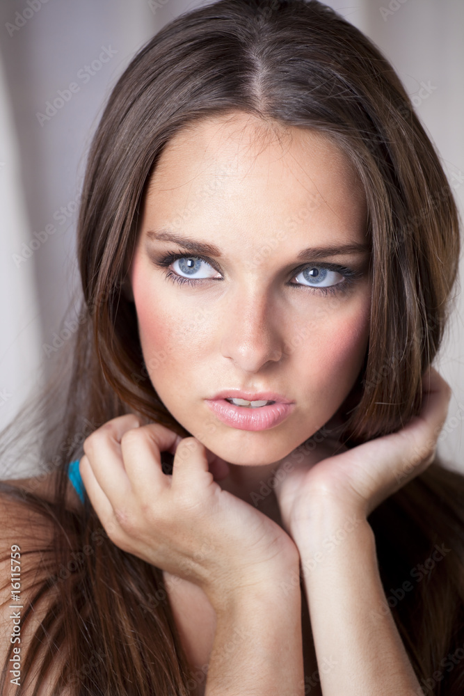 Obraz premium Beautiful Young Woman Holding Her Hair