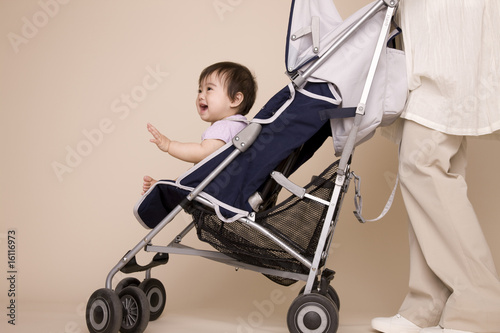 ベビーカーに赤ちゃんを座らせ散歩する母親 photo