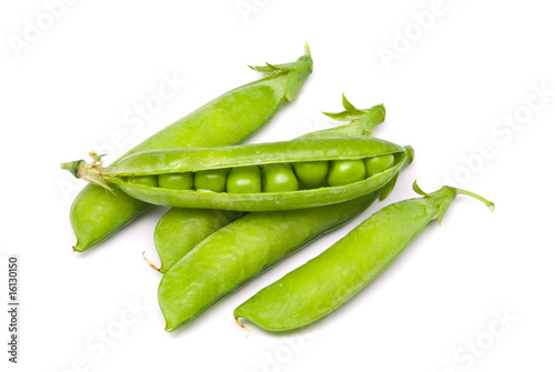 Pods of fresh green peas on a white background