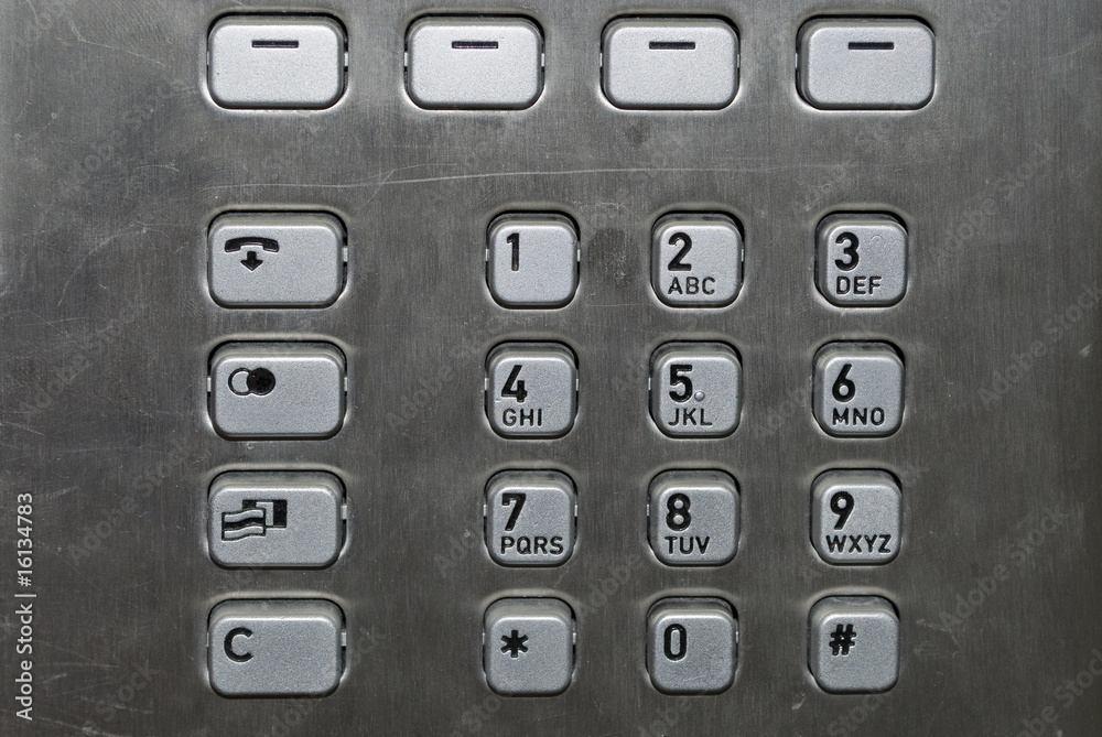 Metallic number pad on a public phone Metallic number pad on a public phone