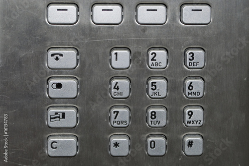 Metallic number pad on a public phone photo