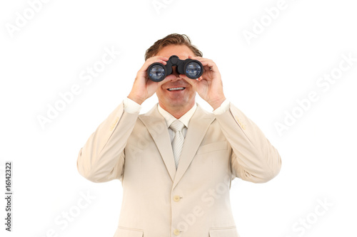 Friendly businessman looking through binoculars