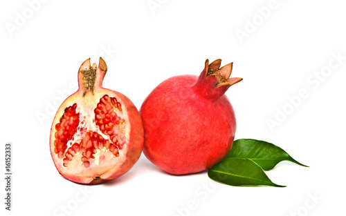 Ripe pomegranate and its section isolated on white background