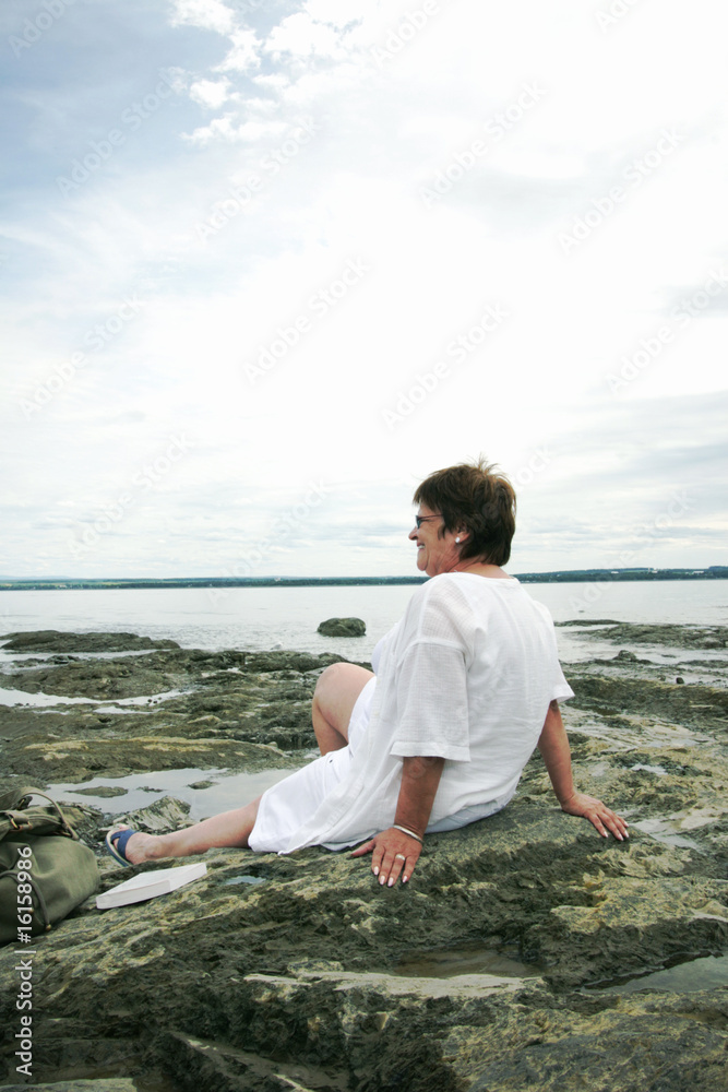 Mature woman relaxing by the water