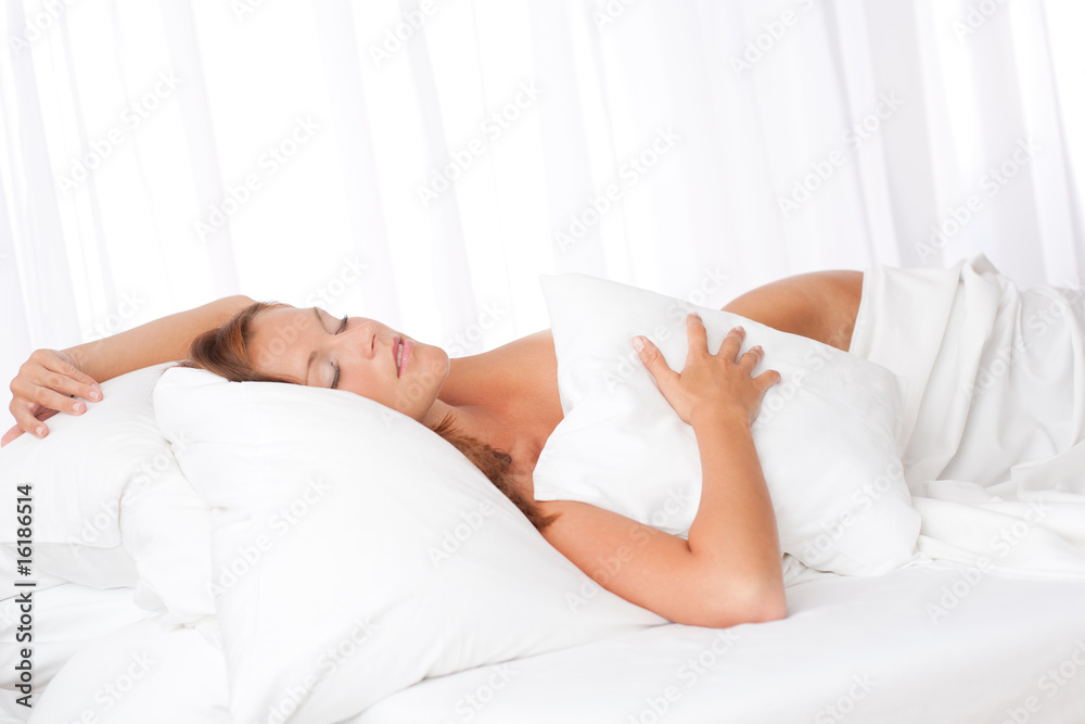 Young woman sleeping in bed