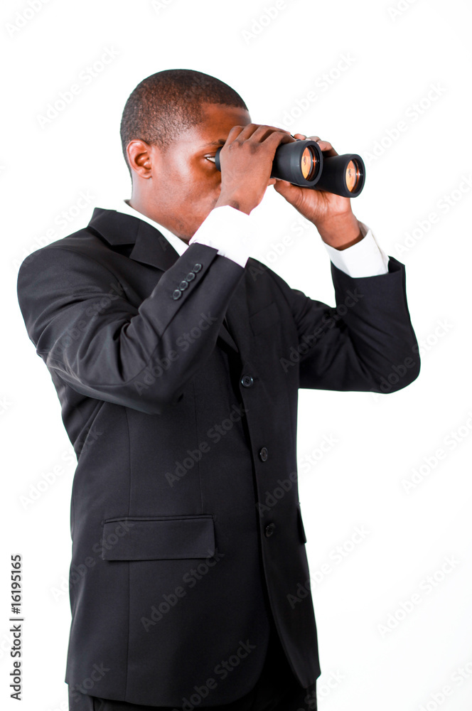 Young businessman looking with binoculars downwards Young businessman looking with binoculars downwards