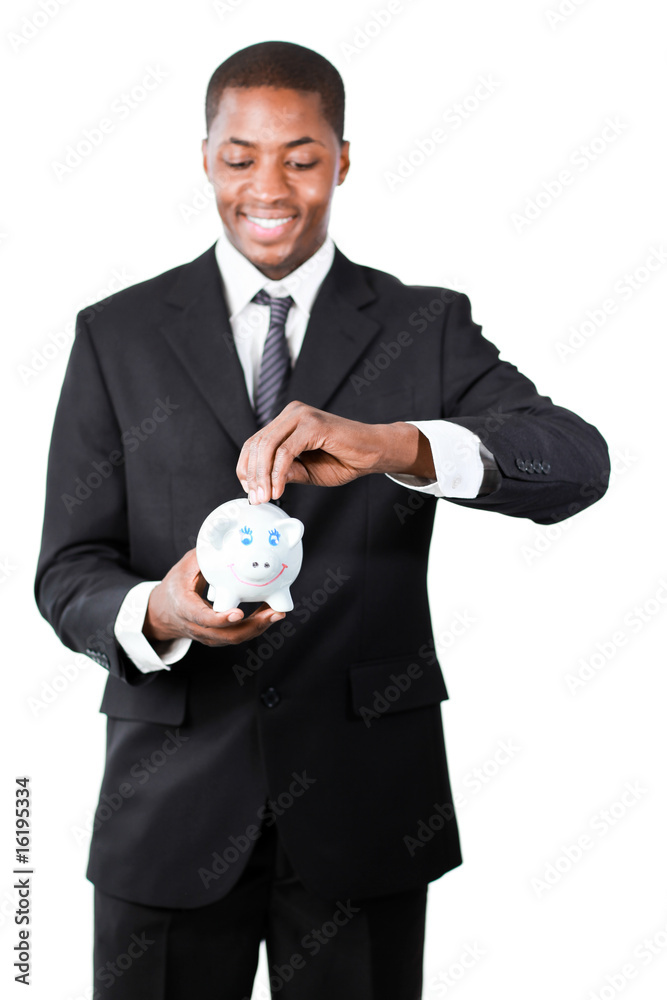 Businessman putting money in his piggy bank Businessman putting money in his piggy bank