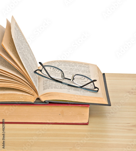 Eyeglasses on open book photo