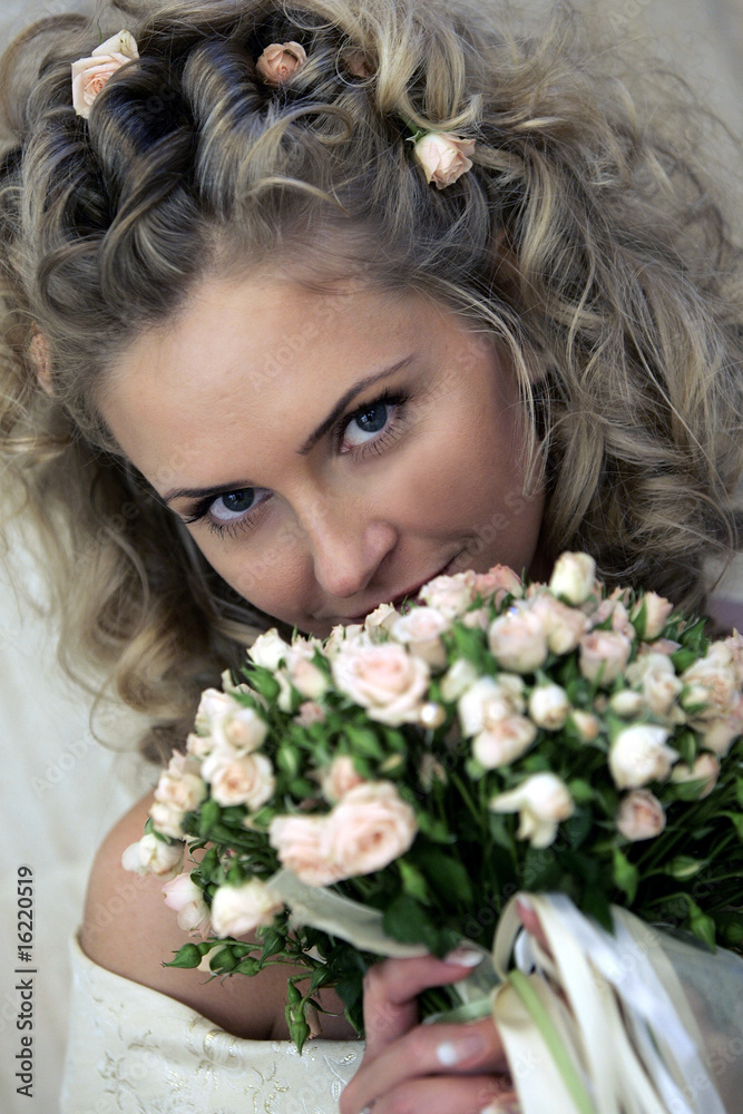 Bride smiling behind bouquet Bride smiling behind bouquet