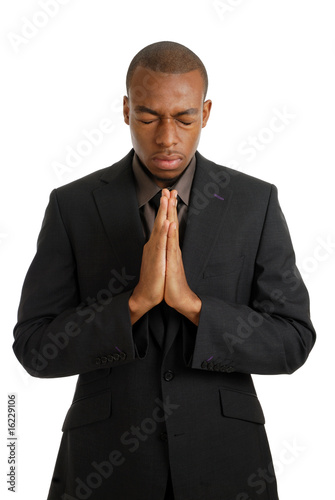 Business man praying with eyes closed