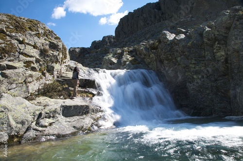 hiking woman next waterfall